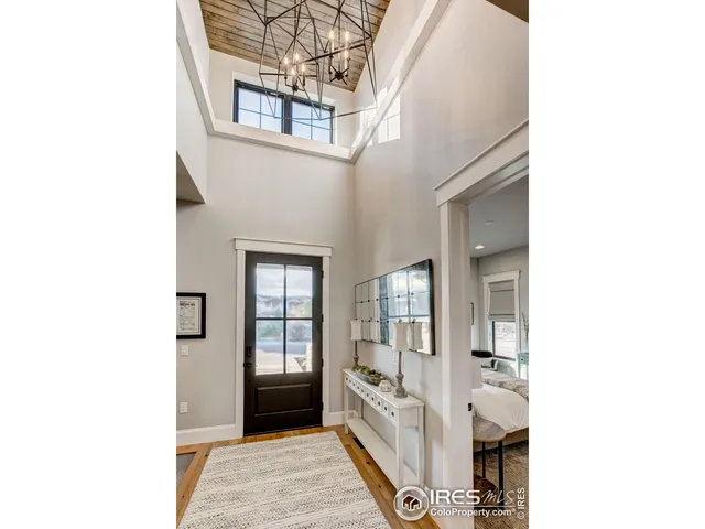 a view of a hallway with bathroom and mirror
