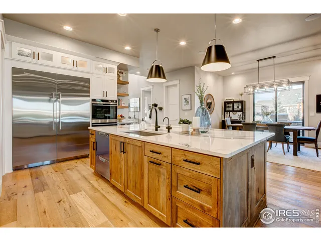a kitchen with stainless steel appliances granite countertop a sink a oven and a refrigerator