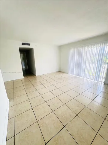 a view of an empty room and a window