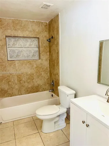 a bathroom with a toilet a sink and bathtub