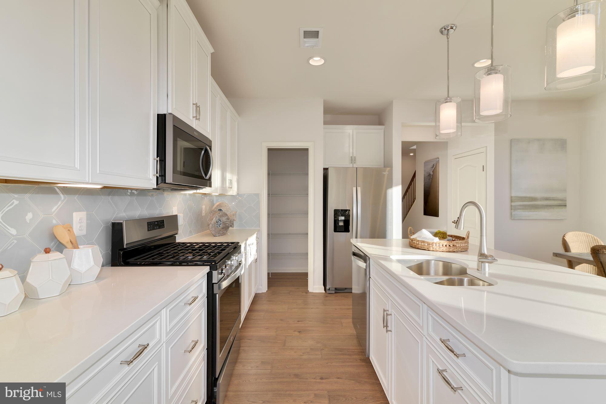 4249 Market Place Perry Hall, MD 21128 - Photo 5 of 17 a kitchen with a sink a counter top space stainless steel appliances and cabinets