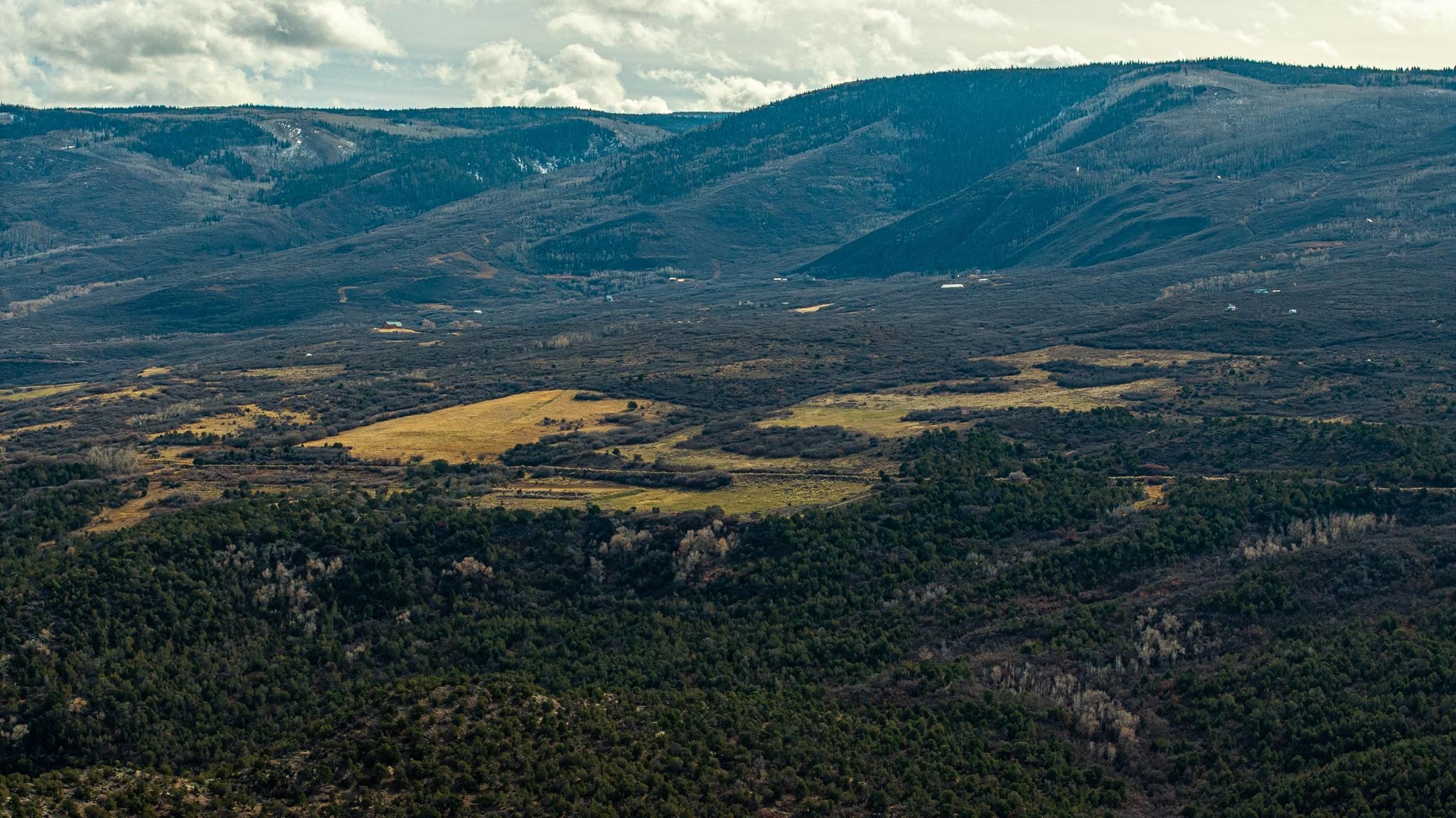 53999 Bull Basin Road Molina, CO 81646 - Photo 25 of 41 a view of a lake in middle of green field