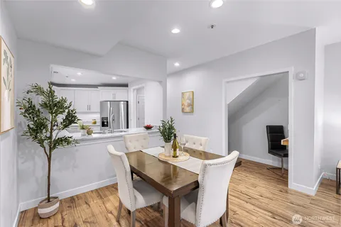 a dining room with furniture and wooden floor