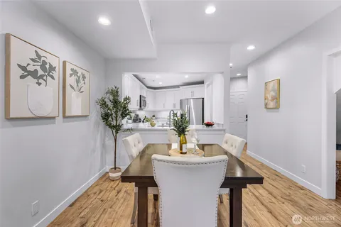 a view of a dining room with furniture and a potted plant