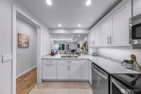 a kitchen with a sink stove and cabinets