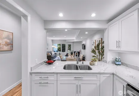 a kitchen with white cabinets and a sink
