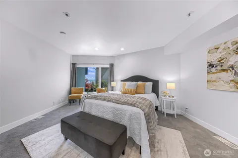 a bedroom with a bed and a couch