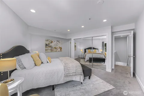 a bedroom with a bed and a view of living room