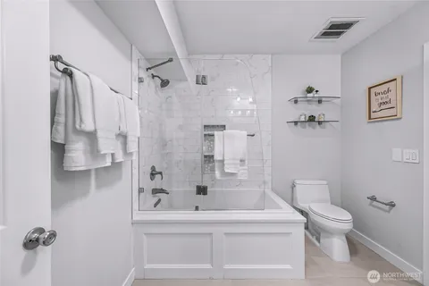 a bathroom with a shower a toilet and a shower