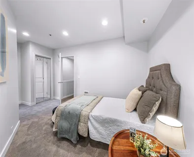 a bedroom with a bed and a painting on the wall