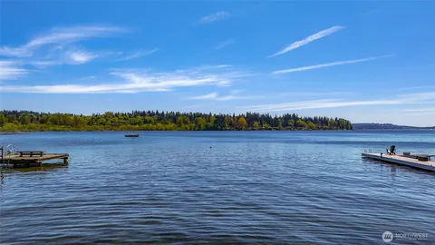 a view of a lake with houses in the back