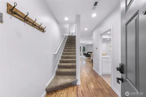 a view of entryway and hall with wooden floor