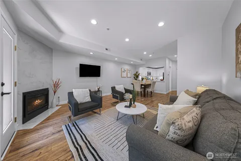 a living room with furniture a fireplace and a flat screen tv