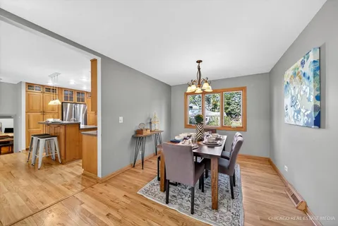 a kitchen with granite countertop a stove and a wooden floors