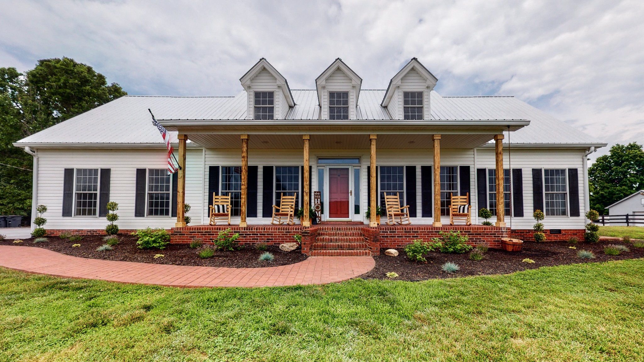 885 Southerland Road Dickson, TN 37055 - Photo 4 of 40 a front view of a house with a yard and porch