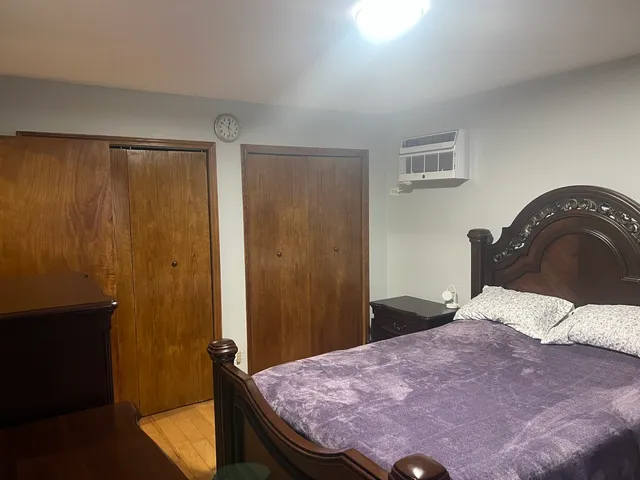 a bedroom with a bed and a dresser