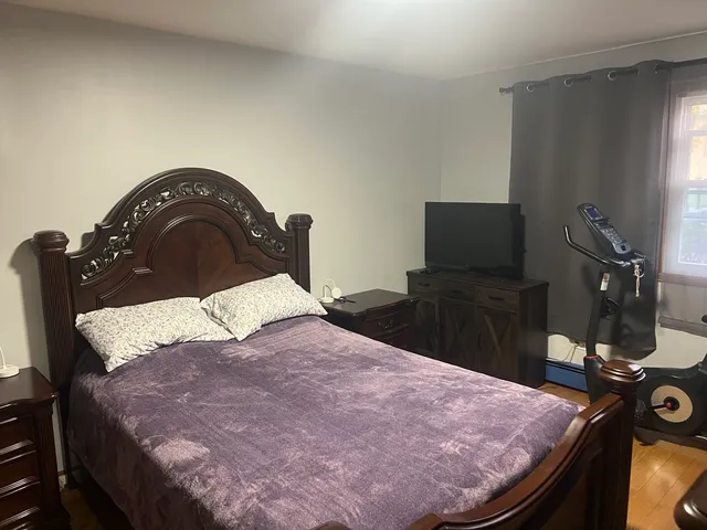 a bedroom with a bed and dresser
