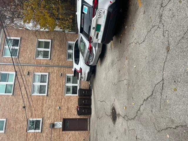 a front view of a house with a tree