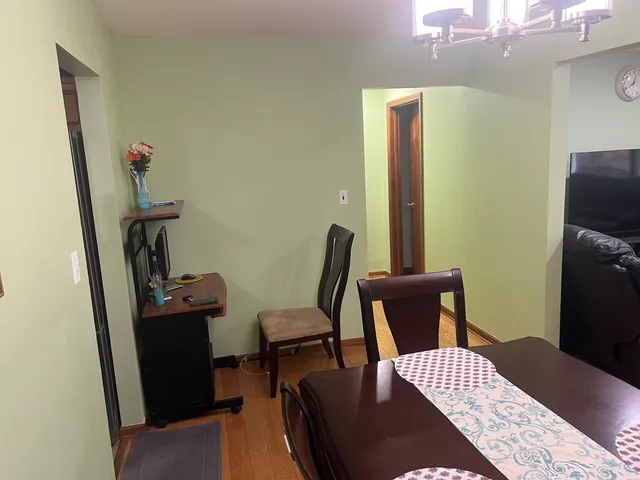a view of a hallway with furniture and wooden floor