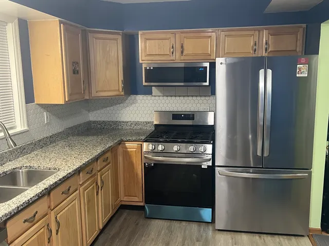 a kitchen with a refrigerator sink and microwave