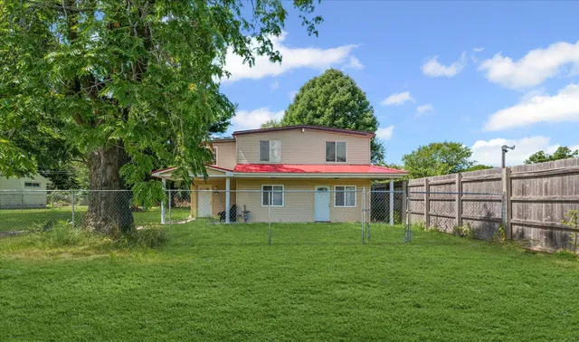 a front view of house with a garden