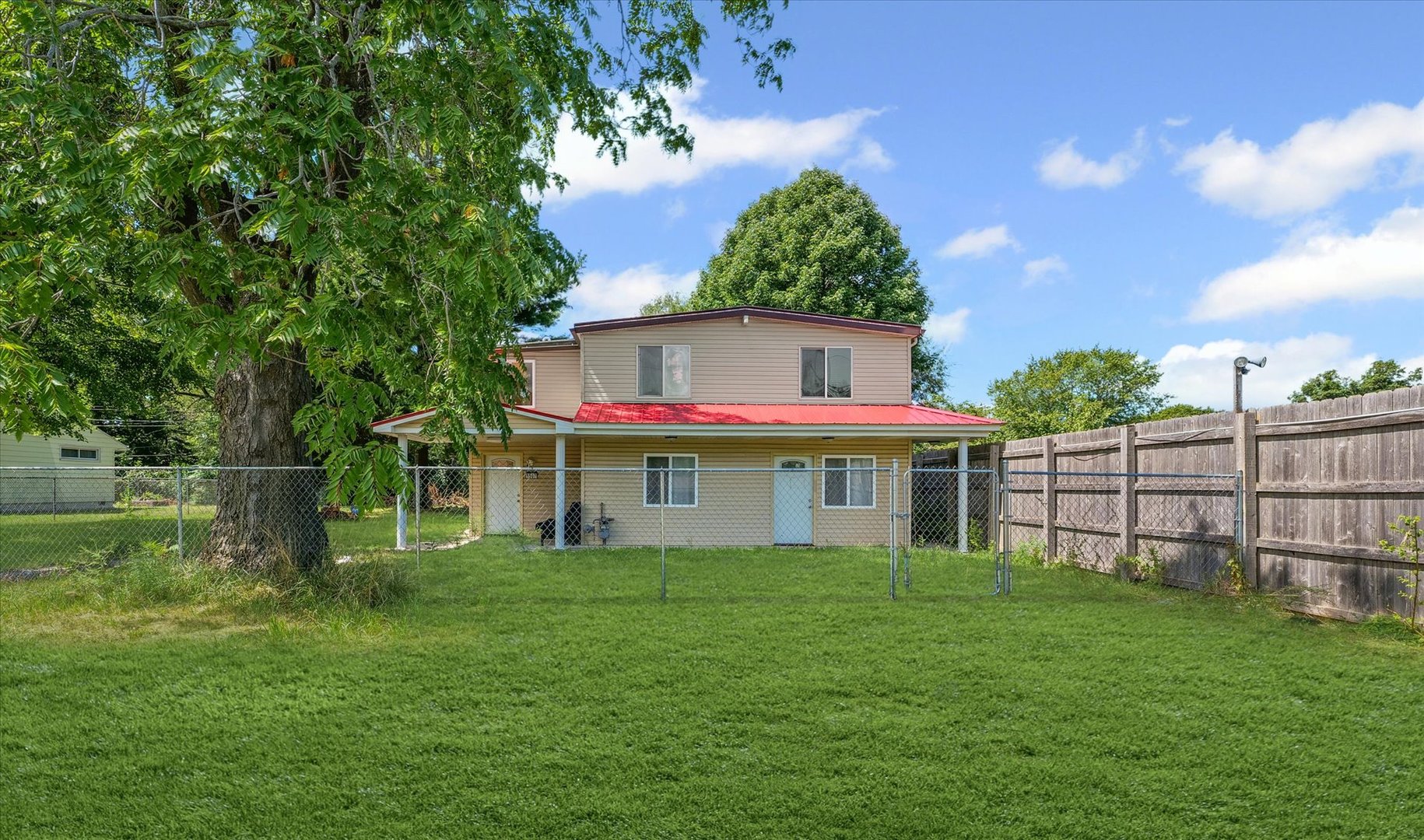 a front view of house with a garden