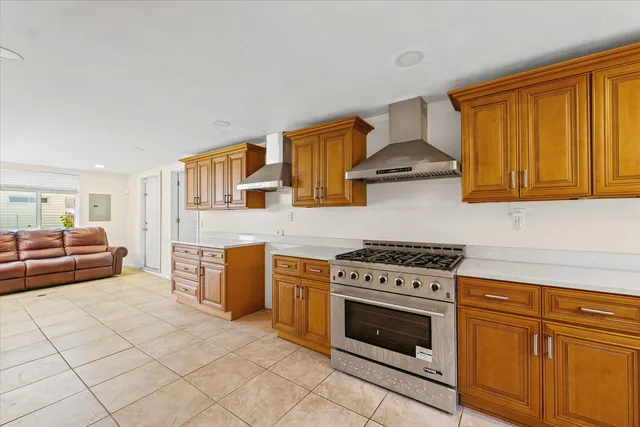 a kitchen with granite countertop a stove top oven microwave and cabinets