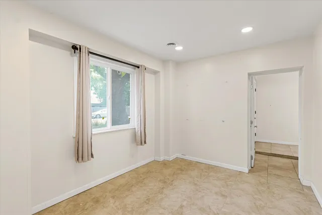 a bathroom with a granite countertop sink a toilet and a mirror