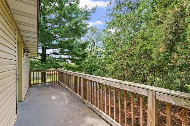 an empty room with wooden floor and bathroom