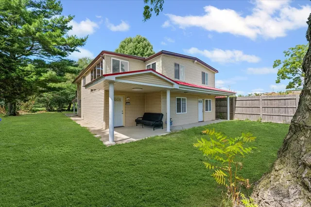 a front view of a house with a garden