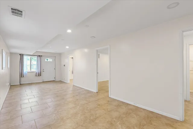 an empty room with windows and closet