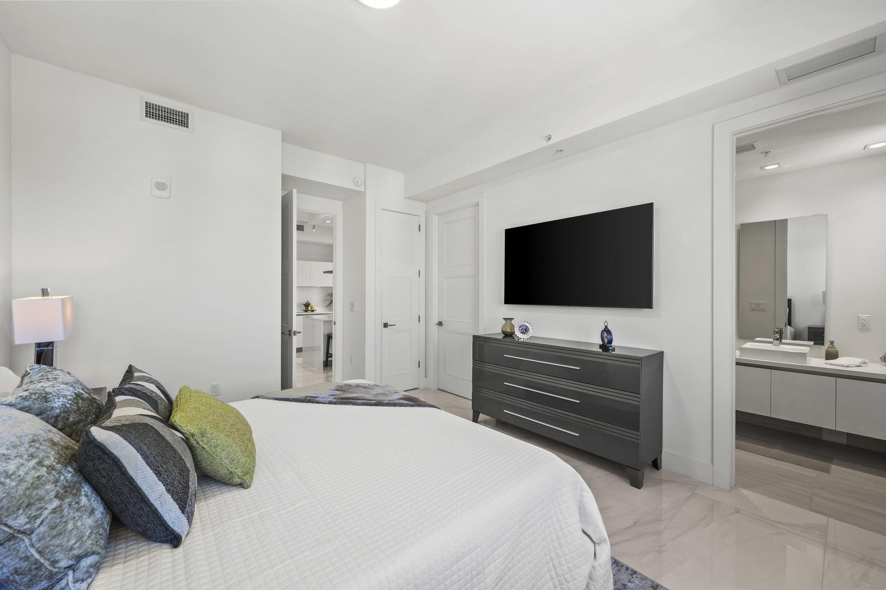 155 East Boca Raton Road, Unit 723 Boca Raton, FL 33432 - Photo 21 of 54 a bedroom with a bed and a flat screen tv