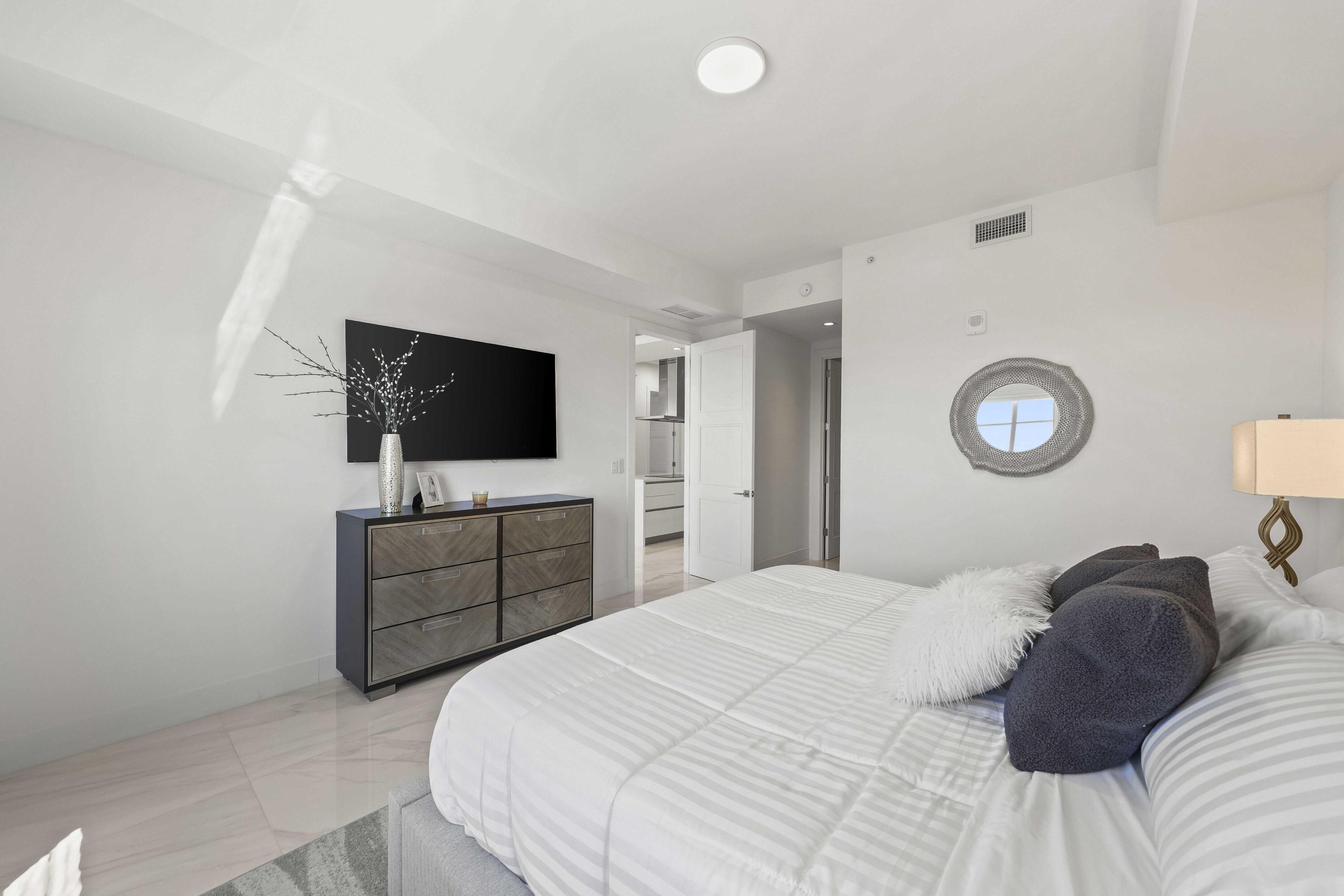 155 East Boca Raton Road, Unit 723 Boca Raton, FL 33432 - Photo 24 of 54 a bedroom with a bed and a flat screen tv