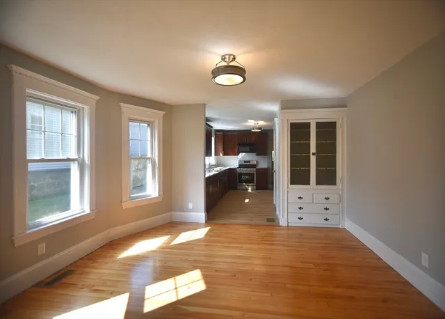 a view of a livingroom with furniture wooden floor and window