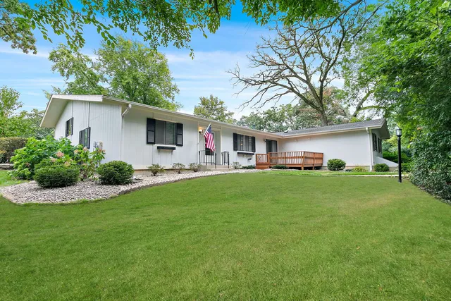 a front view of house with yard and green space