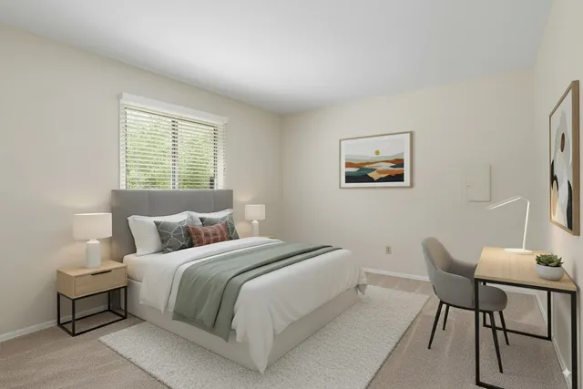 a bedroom with a bed and a couch