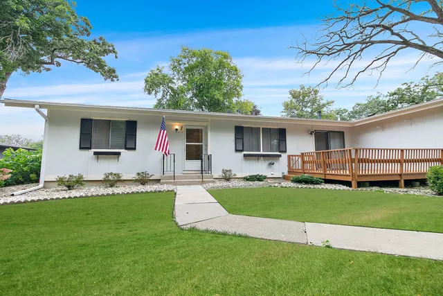 a front view of house with yard patio and green space