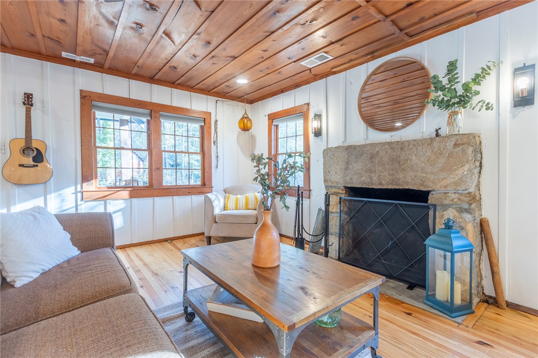 205 Rocky Bottom Road Sunset, SC 29685 - Photo 41 of 46 Rich wood plank ceilings and a massive stone fireplace anchor this cozy rustic room.