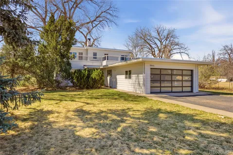 a view of a house with a yard and garage