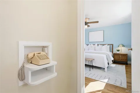 a view of a white house with a large tree