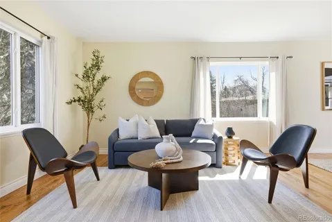a living room with furniture a fireplace and a table