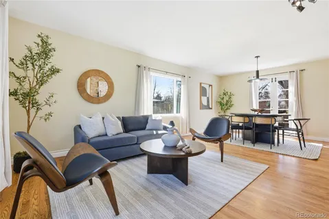 a living room with a fireplace and wooden floor