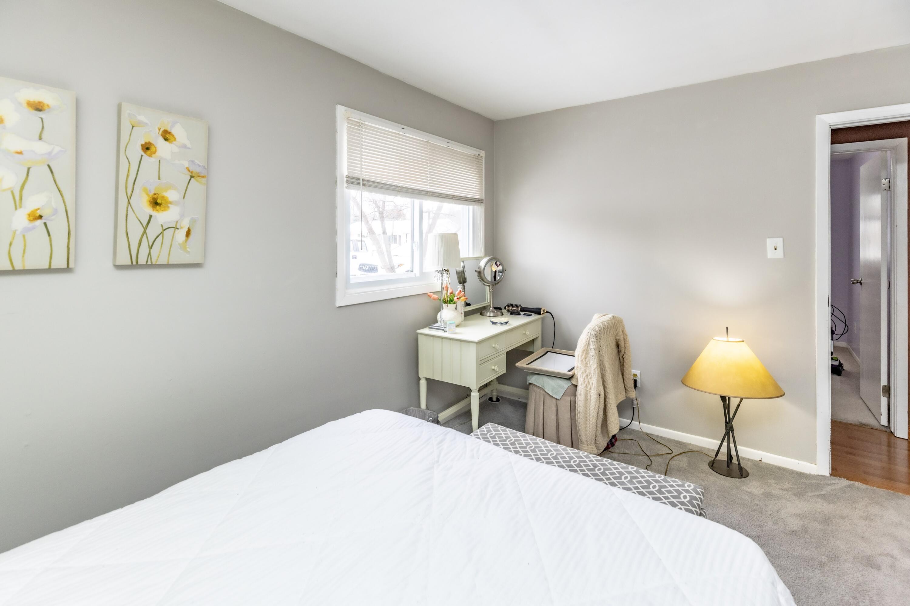 746-1 Acadia Road Valparaiso, IN 46385 - Photo 24 of 44 a bedroom with a bed and a lamp on dresser