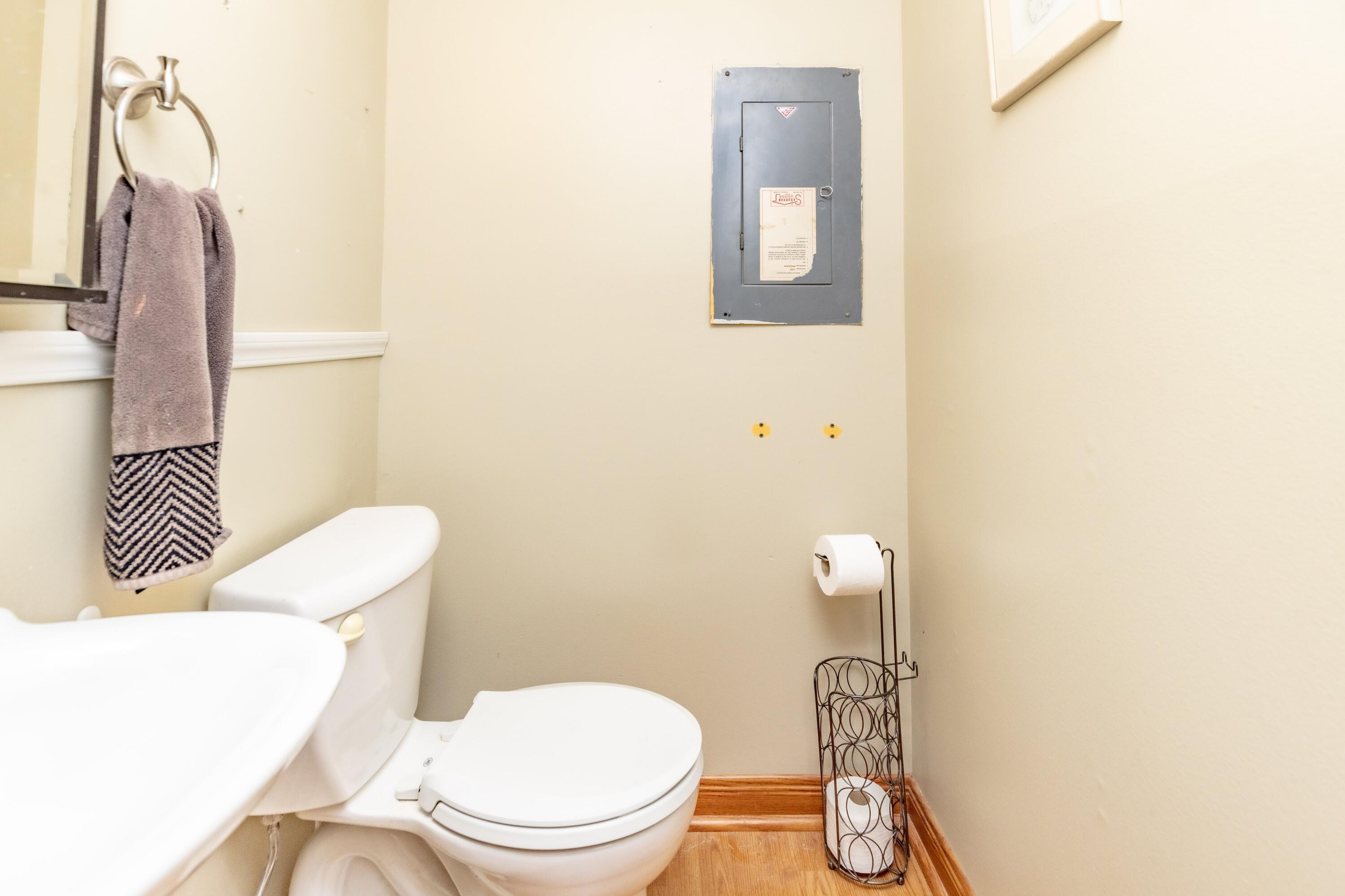 746-1 Acadia Road Valparaiso, IN 46385 - Photo 26 of 44 a white toilet sitting next to a bathroom sink and vanity