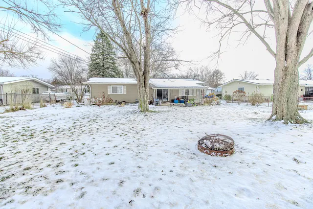 a kitchen with stainless steel appliances a stove a refrigerator a oven with white cabinets and wooden floor