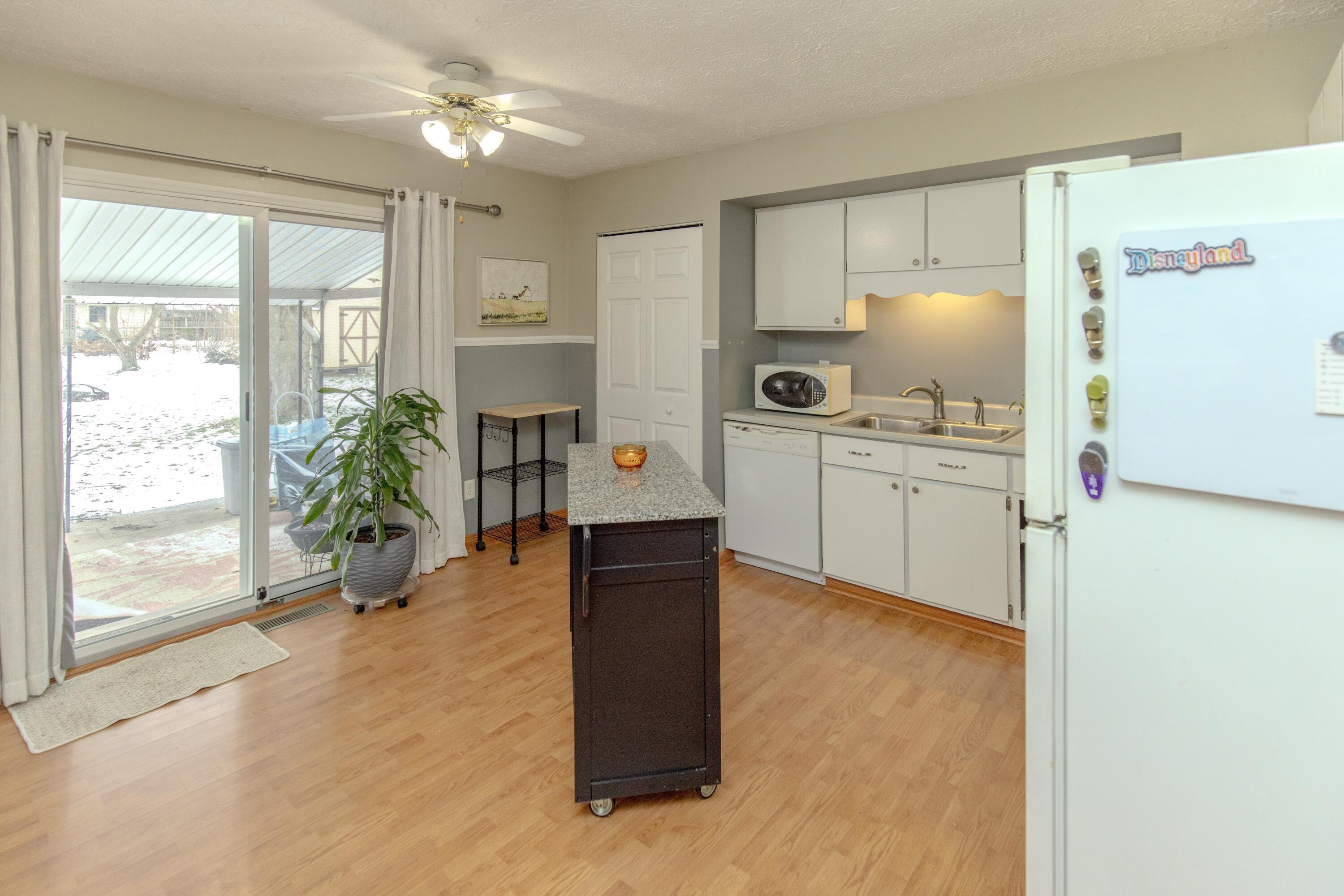 746-1 Acadia Road Valparaiso, IN 46385 - Photo 36 of 44 a kitchen with stainless steel appliances a stove a refrigerator a oven with white cabinets and wooden floor