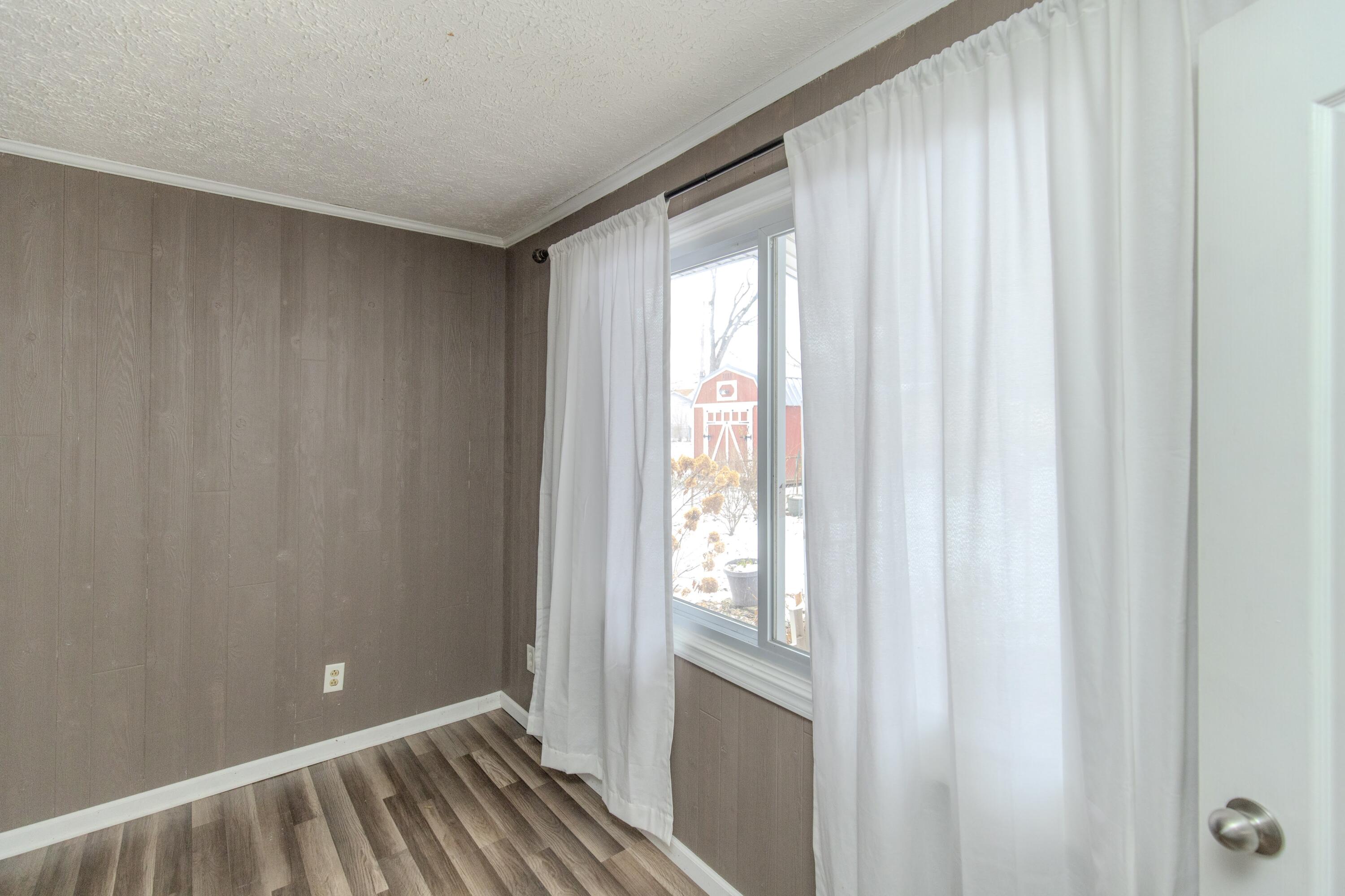 746-1 Acadia Road Valparaiso, IN 46385 - Photo 39 of 44 a view of an empty room with wooden floor and a window