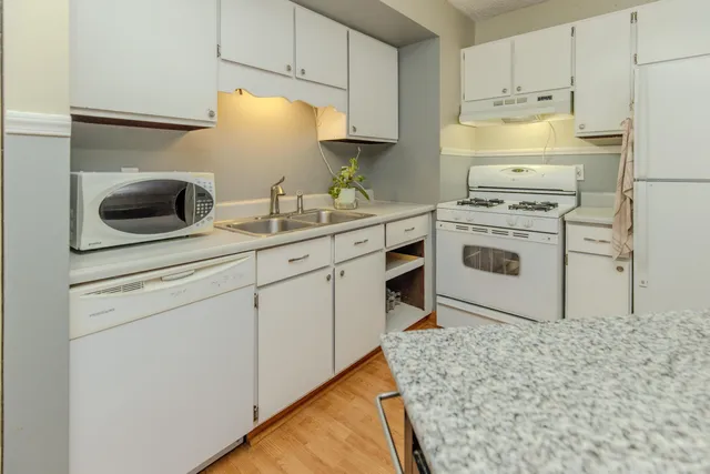 a view of a yard with wooden fence