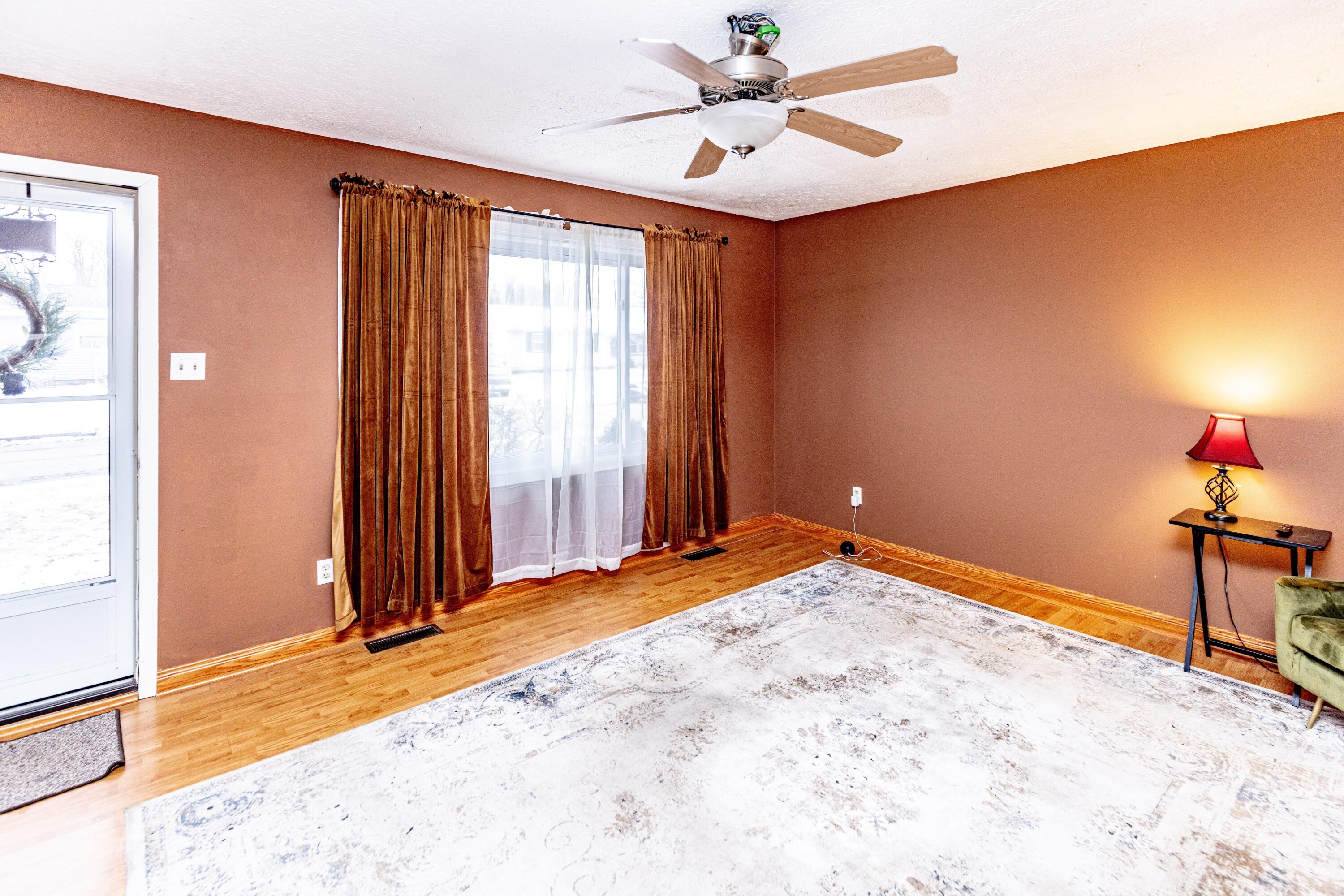 746-1 Acadia Road Valparaiso, IN 46385 - Photo 10 of 44 an empty room with a chandelier fan and windows