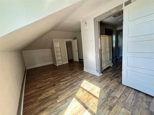 a view of hallway with wooden floor